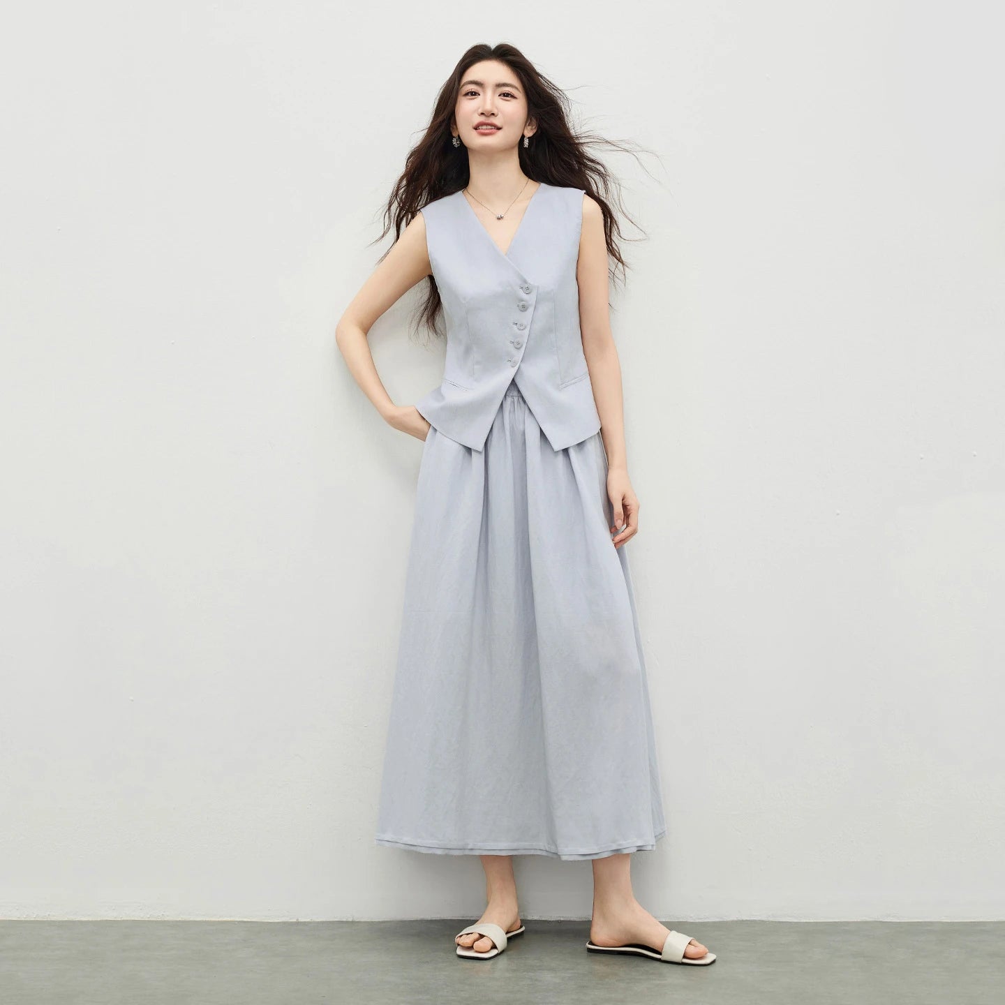 Women's two-piece set: sleeveless asymmetrical vest with tonal buttons and a flared midi skirt with an elasticated waistband. Shown in Lavender Mist color. — From Borcelleclothes.