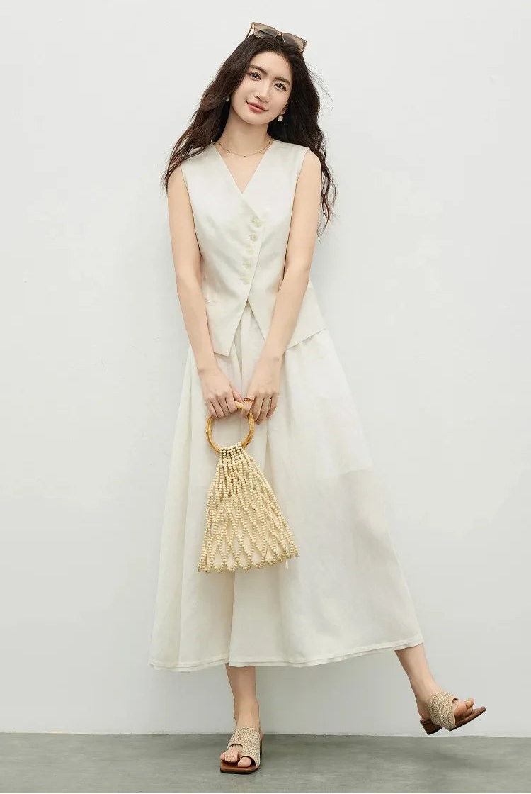 Woman in a muted chord two-piece set, showcasing the skirt's fluid movement and hem pleat — From Borcelleclothes.