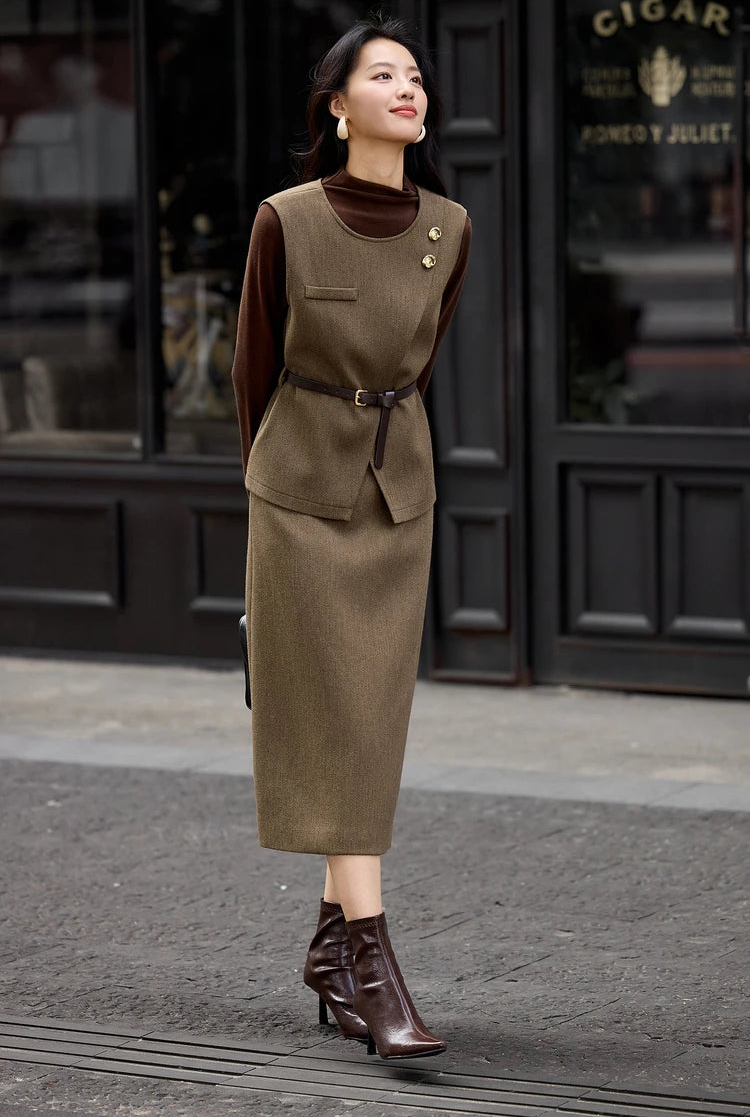 Asymmetrical olive-brown wool blend vest and skirt set, model posing with a bag behind her back, Istanbul cinematic style — From Borcelleclothes.