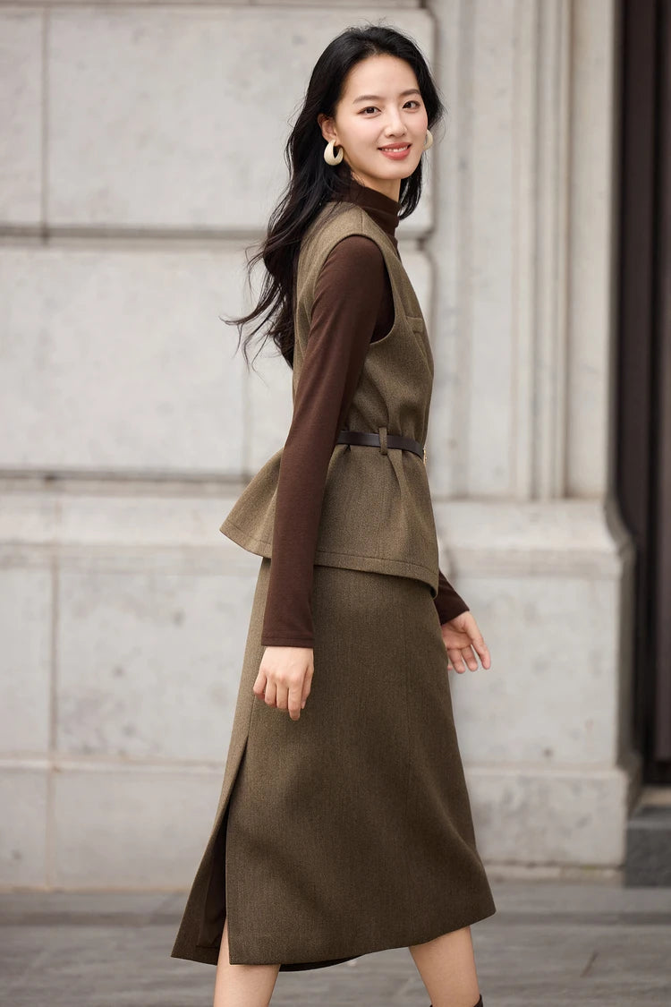 Side view of the asymmetrical wrap vest and midi skirt, showing the sharp tailoring and silhouette — From Borcelleclothes.