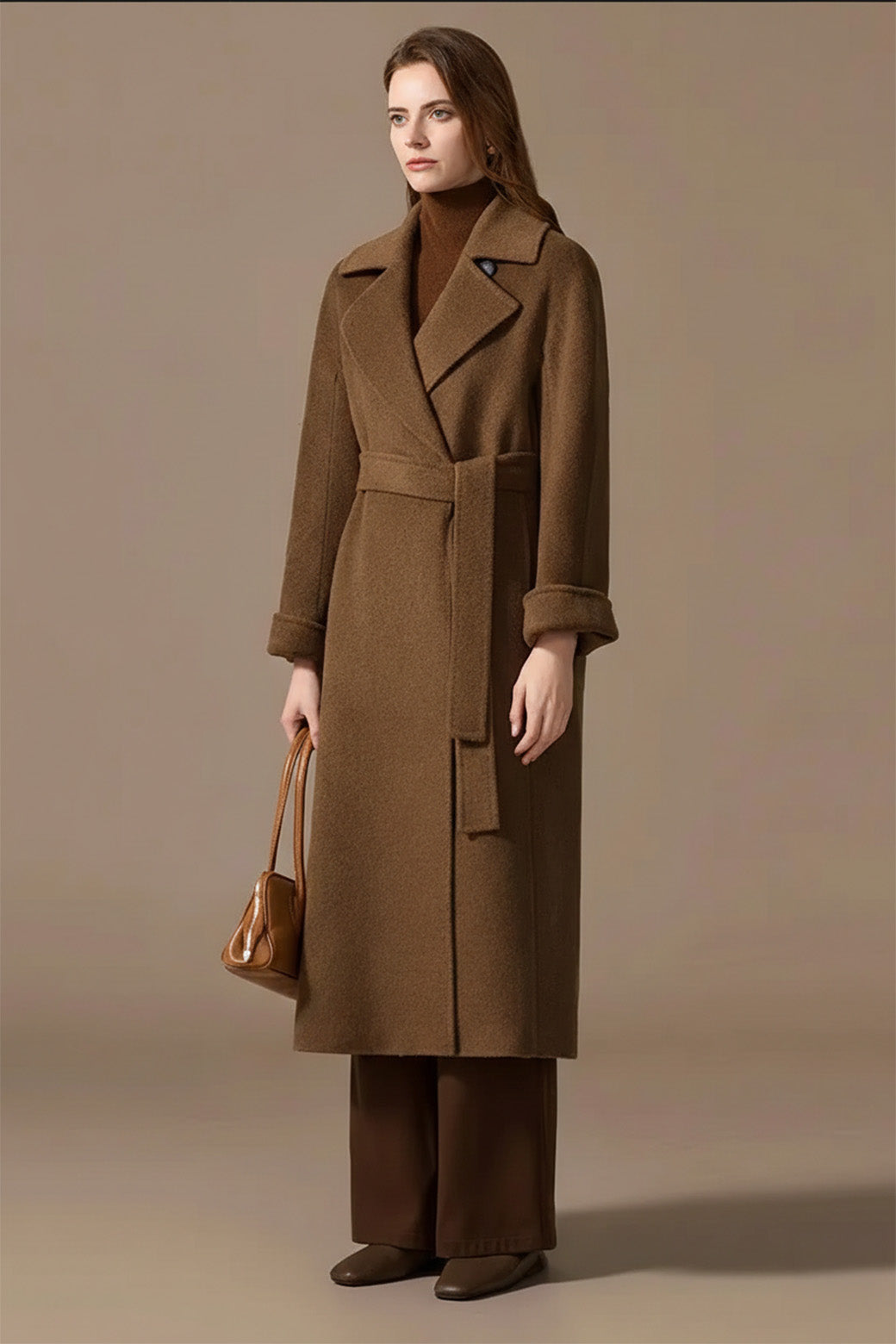 Side profile of a woman in the Gobi Haze coat, emphasizing the weightless volume of the premium wool. From Borcelleclothes.