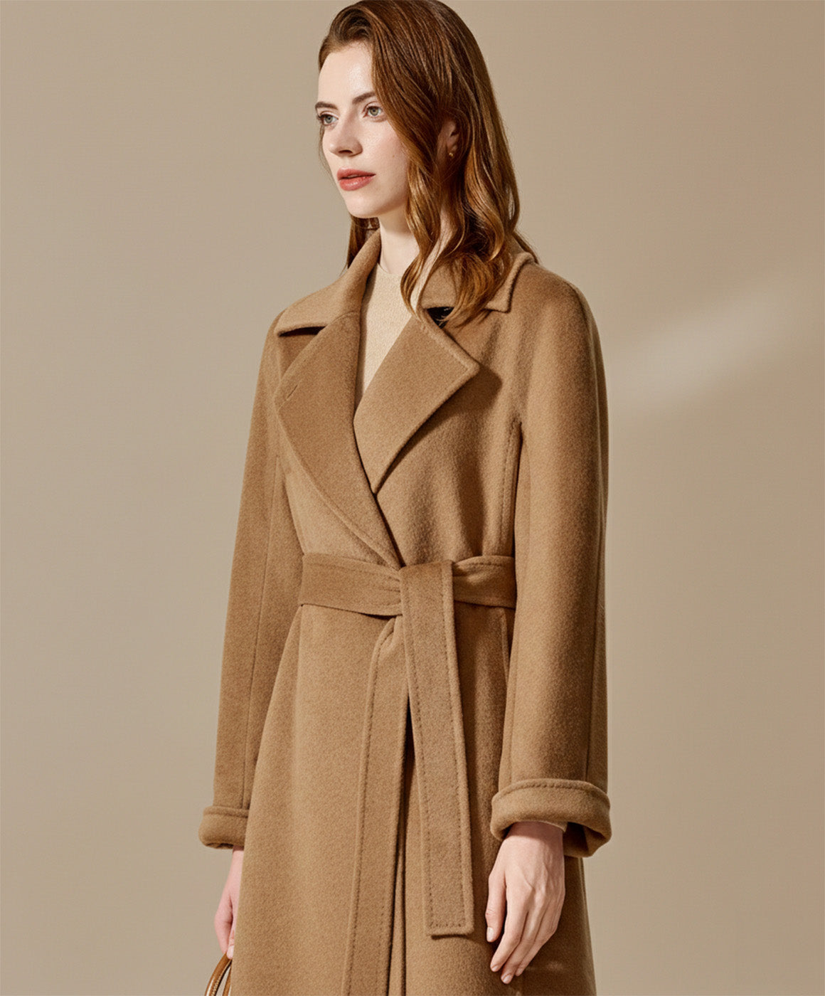 Portrait of a woman wearing the Tumbleweed coat with the pointed collar buttoned high against the cold. From Borcelleclothes.