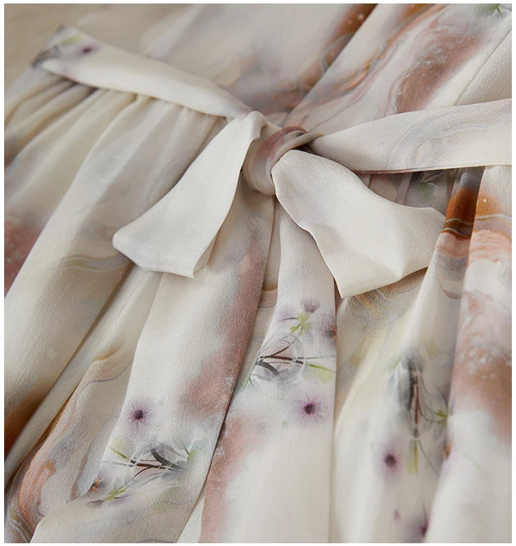 Detailed view of the long silk sashes tied into a soft, romantic bow at the back of the woman's waist — From Borcelleclothes.