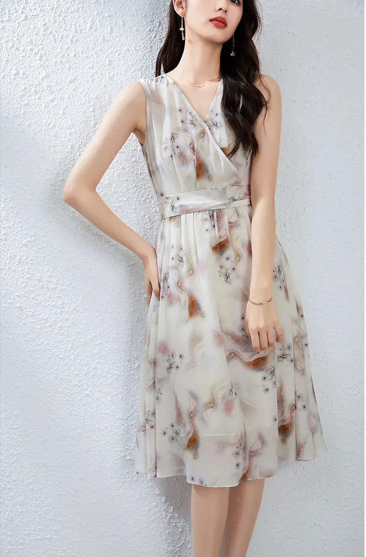 A woman standing with her hand on her hip, looking up with a serene expression that complements the ethereal misty dandelion print — From Borcelleclothes.