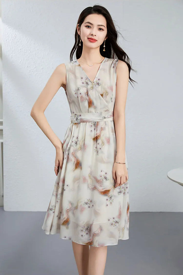 A woman posing with one hand on her hip, accentuating the defined waist and the elegant crossover structure of the silk bodice — From Borcelleclothes.
