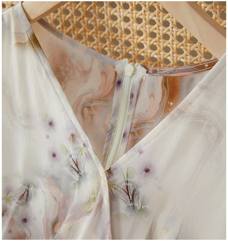 Close-up of the elegant wrap V-neckline resting softly against the woman's collarbone, showing the premium finish of the silk — From Borcelleclothes.