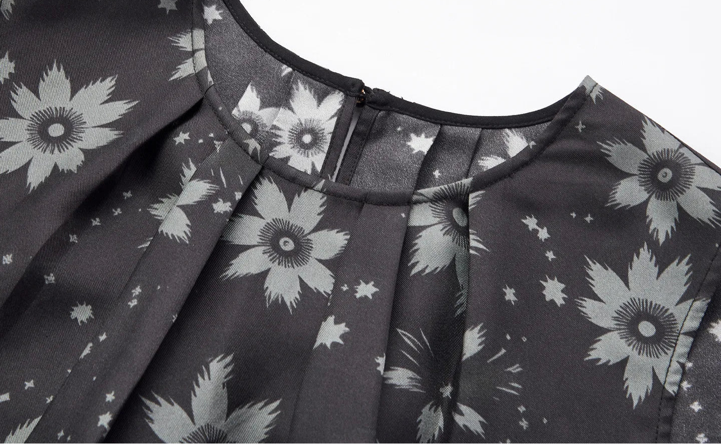 Detailed view of the front bias-bound neckline with knife and inverted box pleats in Muted Sundrop silk twill — From Borcelleclothes.