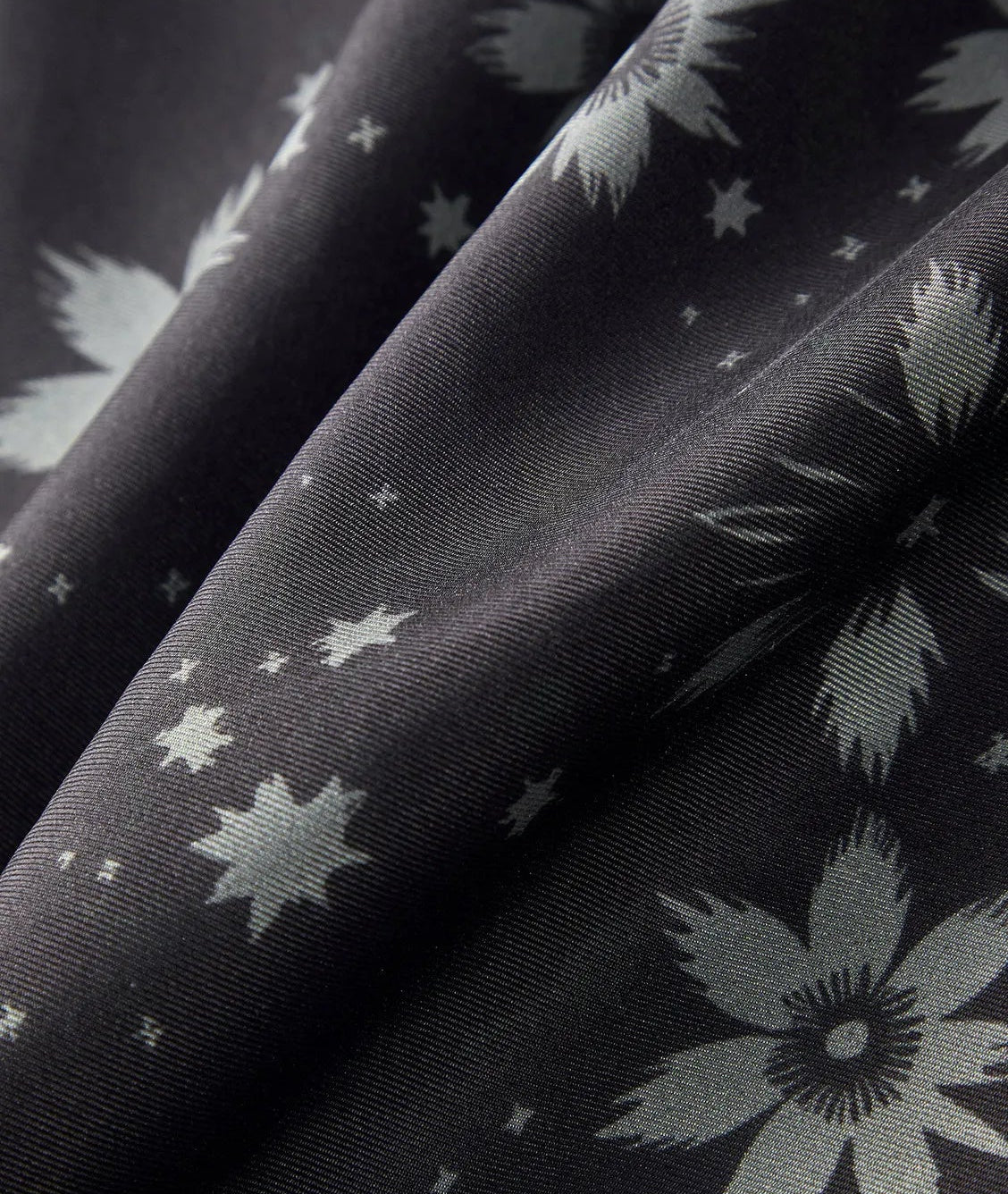 Close-up of soft wave-folded 18 Momme silk twill fabric highlighting the diagonal weave and Sundrop pattern — From Borcelleclothes.