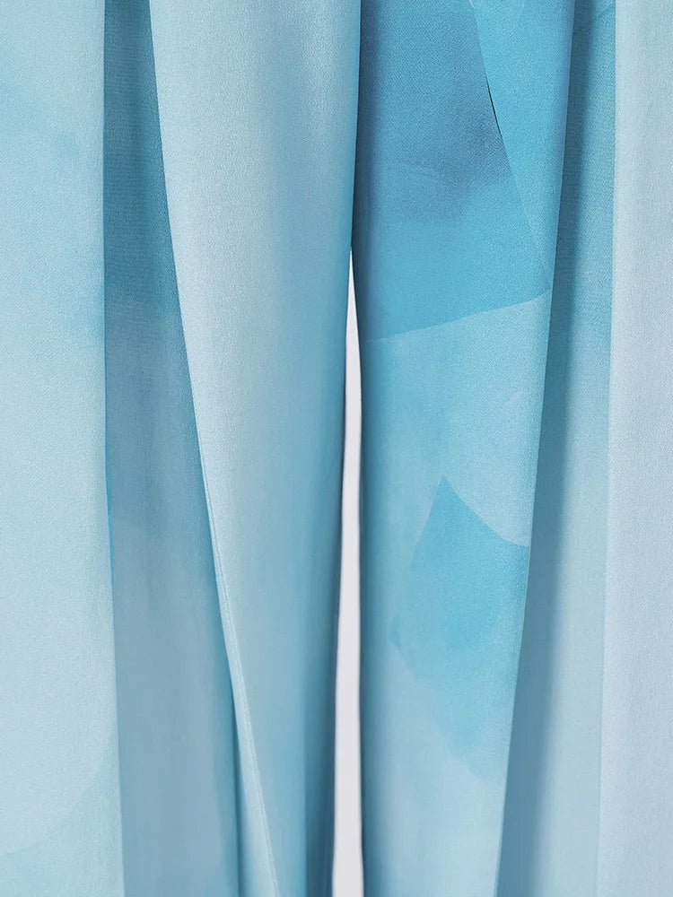 Close-up on the liquid sheen and soft watercolor gradients of heavy silk in motion — From Borcelleclothes.