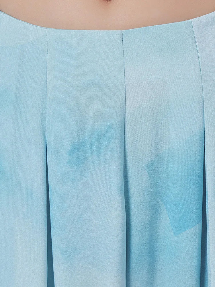 Precision in tailored silk — four deep box pleats unfolding down from the waist — From Borcelleclothes.