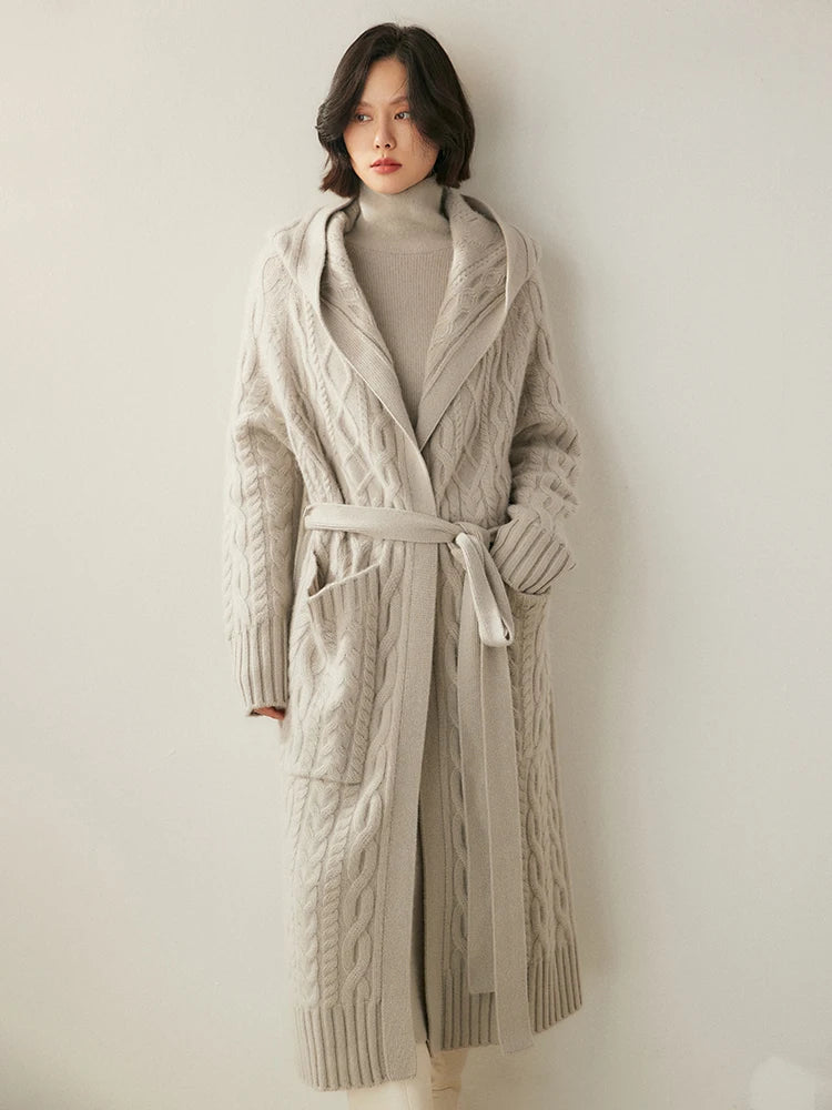 Women's  Cable-Knit Cashmere Wool Coat in Pearl Bush, featuring intricate cable patterns, a loose-fitting silhouette, a wide ribbed bottom hem, large functional pockets, and an integrated hood for a timeless yet modern design, Borcelleclothes.