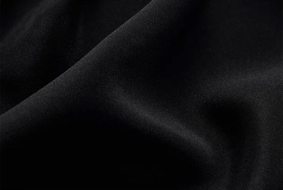 Softly folded Calculated Canvas silk-viscose crepe fabric demonstrating its matte luster, supple weight, and refined pebble-grain surface — From Borcelleclothes.