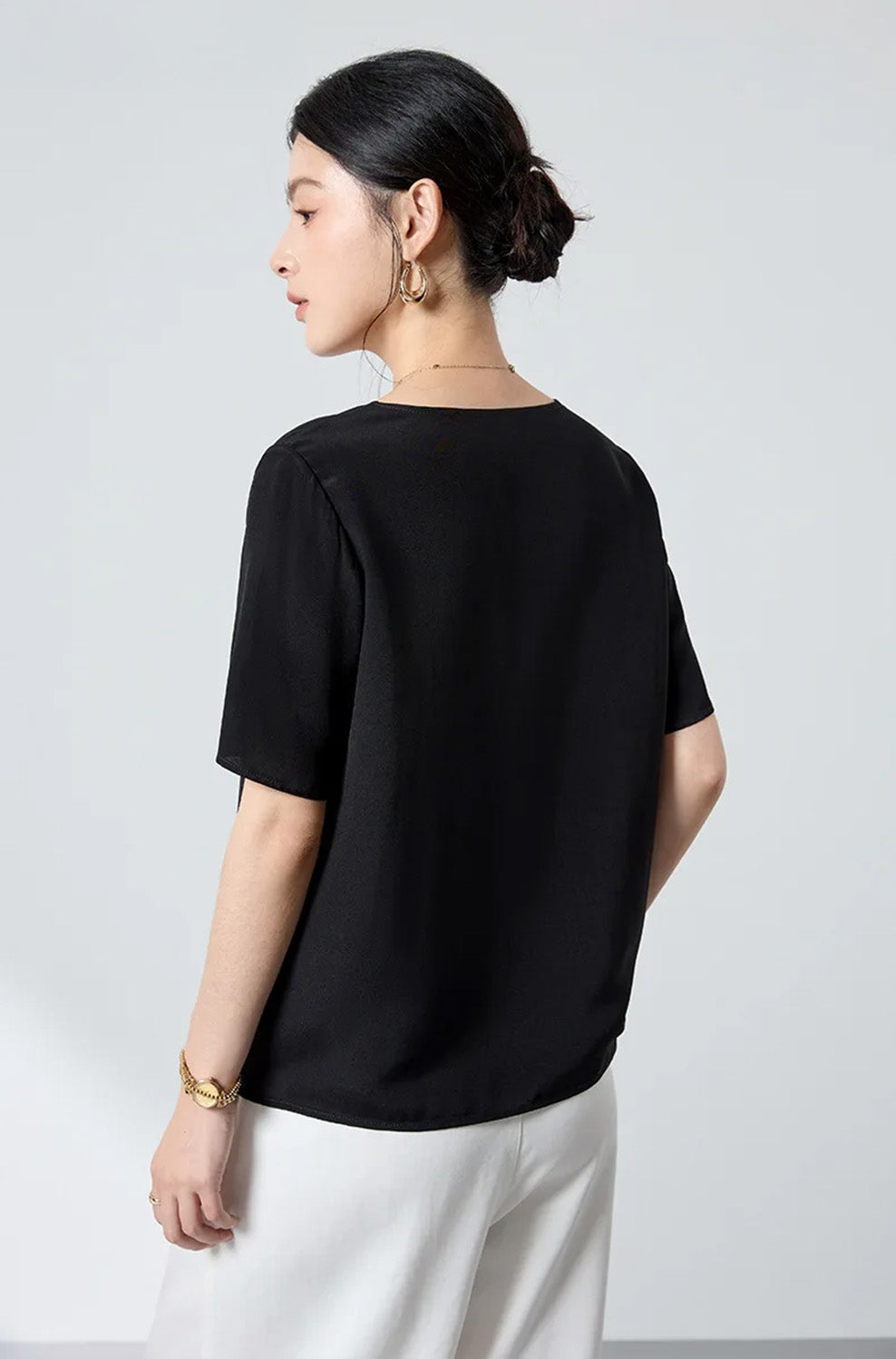 Back view of the Calculated Canvas matte silk-viscose top illustrating the clean shoulder seam alignment and relaxed, flowing silhouette — From Borcelleclothes.
