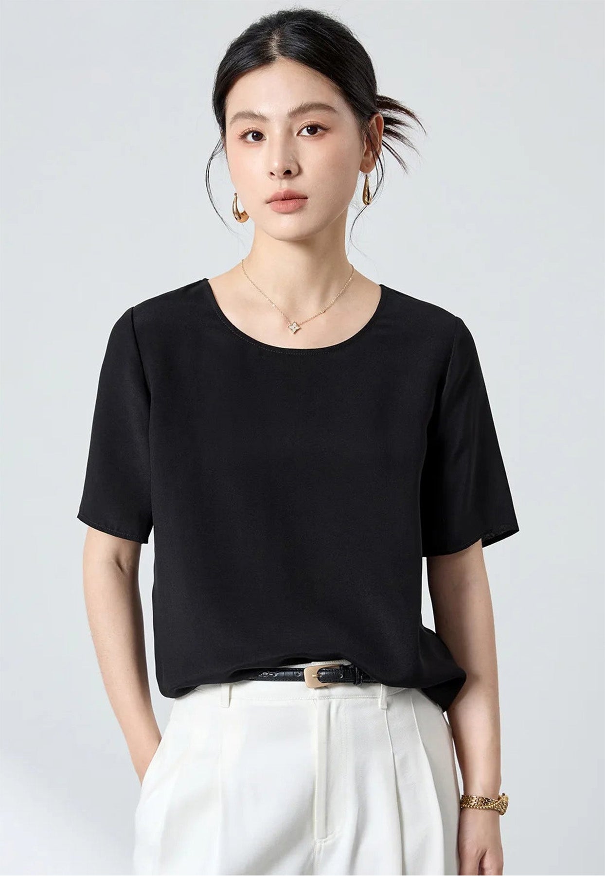 Portrait of a model wearing the Calculated Canvas silk-viscose top with one hand in her pocket, looking directly toward the camera — From Borcelleclothes.