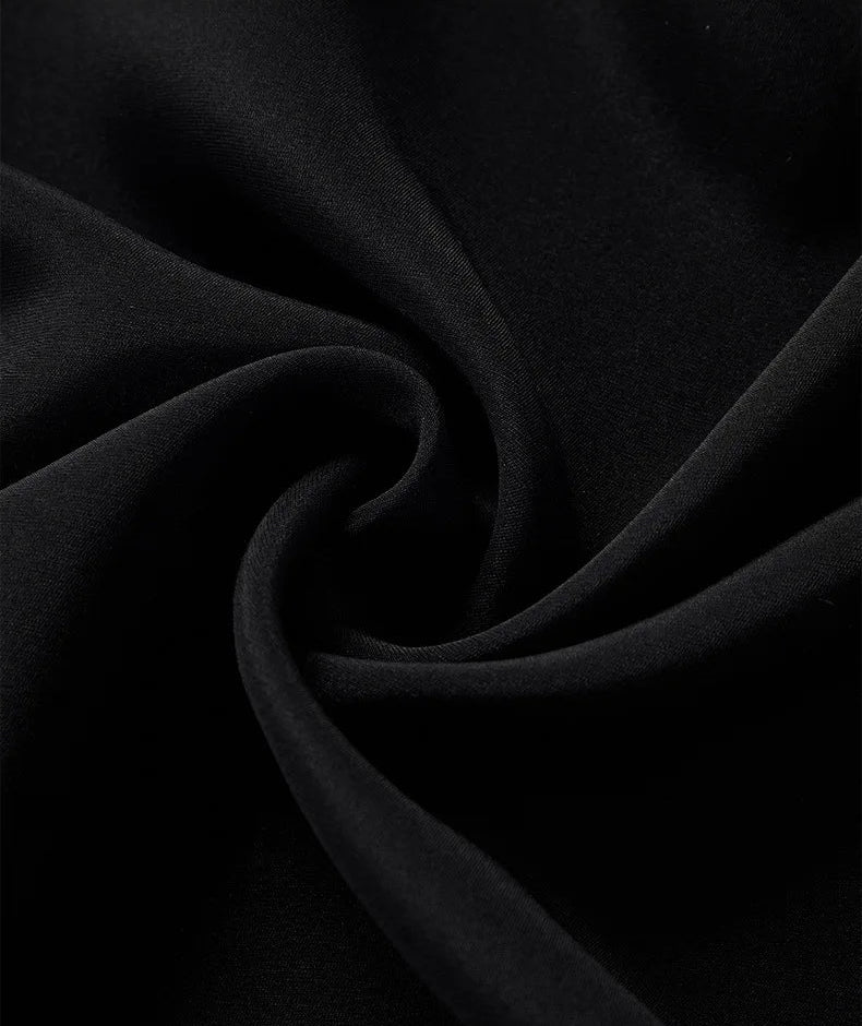 Spiral-folded view highlighting the fluid drape, dense 20 momme texture, and subtle pebble grain of the Calculated Canvas silk-viscose crepe fabric — From Borcelleclothes.