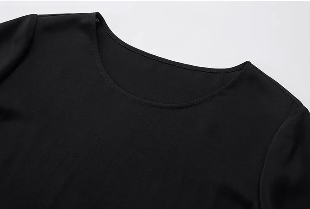 Close-up of the upper bodice showing the classic round neckline, smooth shoulder fit, and matte crepe finish in Calculated Canvas — From Borcelleclothes.