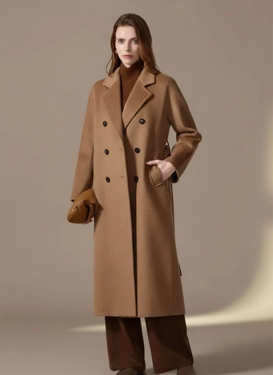 Front view of a double-breasted camel velvet coat in Breath of Saffron, model with hand in pocket. From Borcelleclothes.