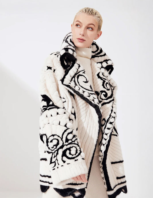 Women’s carved mink fur mosaic overcoat in Nordic Queen with Forêt Noire hem. Features a flared silhouette and folkloric high-relief texture. — From Borcelleclothes.