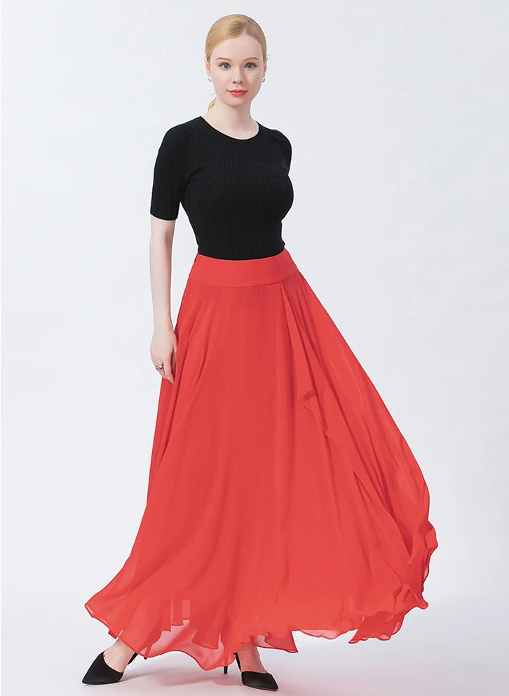 A model swirling to the left, capturing the dramatic movement and fluid drape of the Wild Blush silk maxi skirt — From Borcelleclothes.