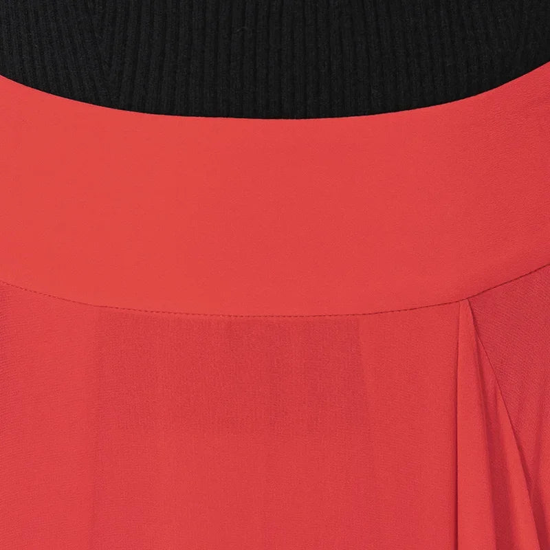 Close-up of the structured waist yoke and the free-flowing angled panel integrated into the front seam — From Borcelleclothes.
