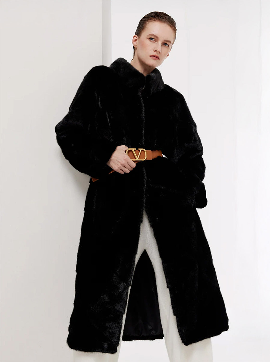 Women’s chevron sheared mink coat in Beyond Black, model touching leather belt — From Borcelleclothes.