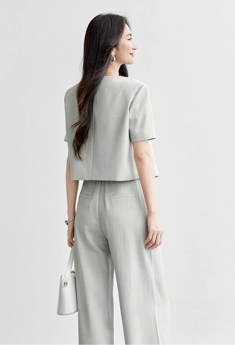 Back view of a woman wearing the cropped jacket and wide-leg trousers, showing the clean lines and partially elasticated waistband. From Borcelleclothes.