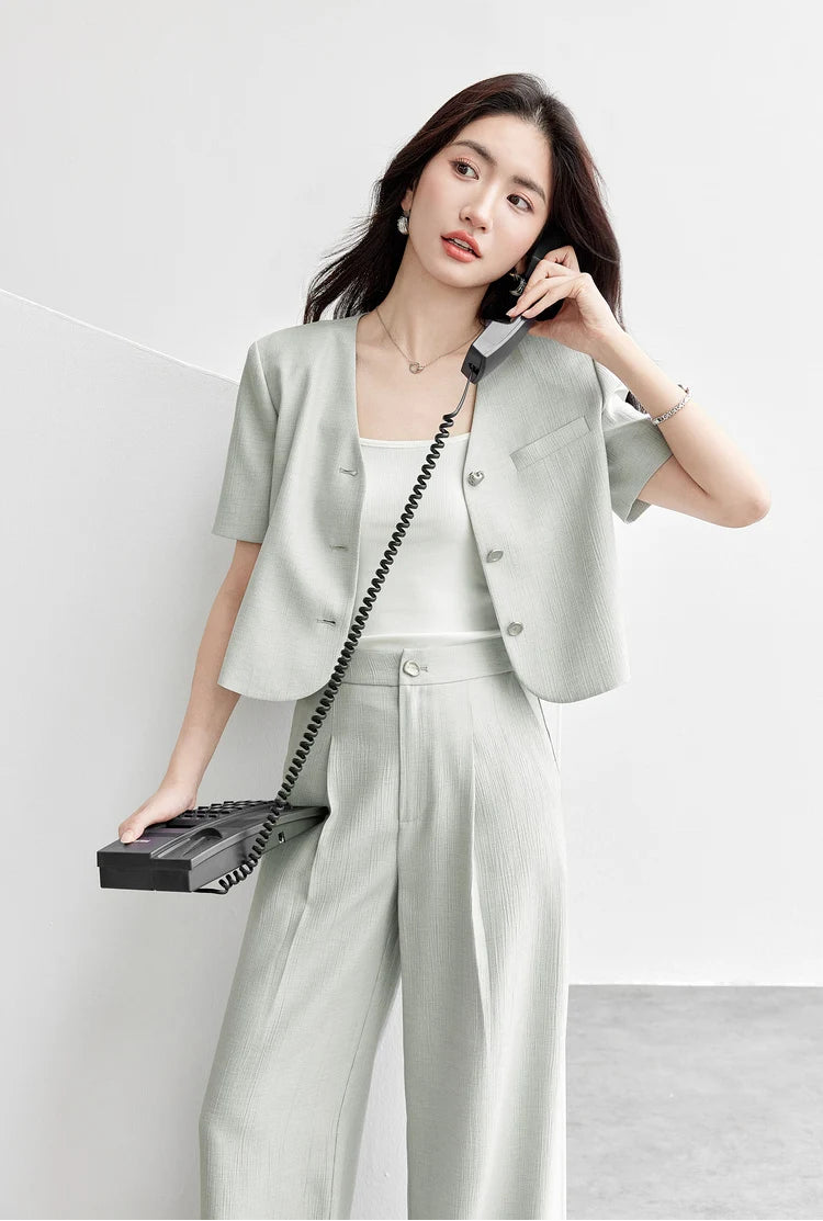 A woman making phone calls in a Named by Frost set, capturing the lighthearted irony and cooling comfort of the crinkled fabric. From Borcelleclothes.
