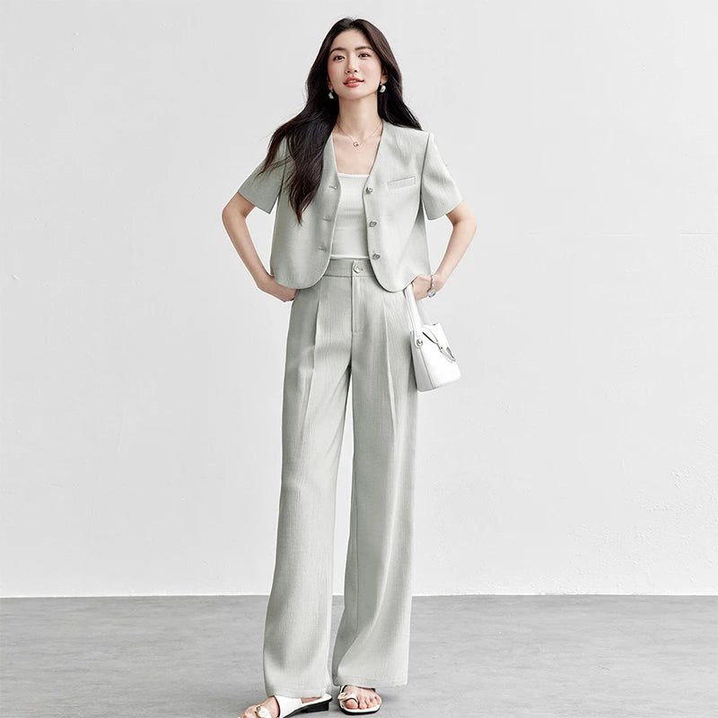 Women's crinkled viscose suit in Named by Frost color featuring cropped short-sleeve jacket with no collar and matching wide-leg pleated trousers. — From Borcelleclothes.