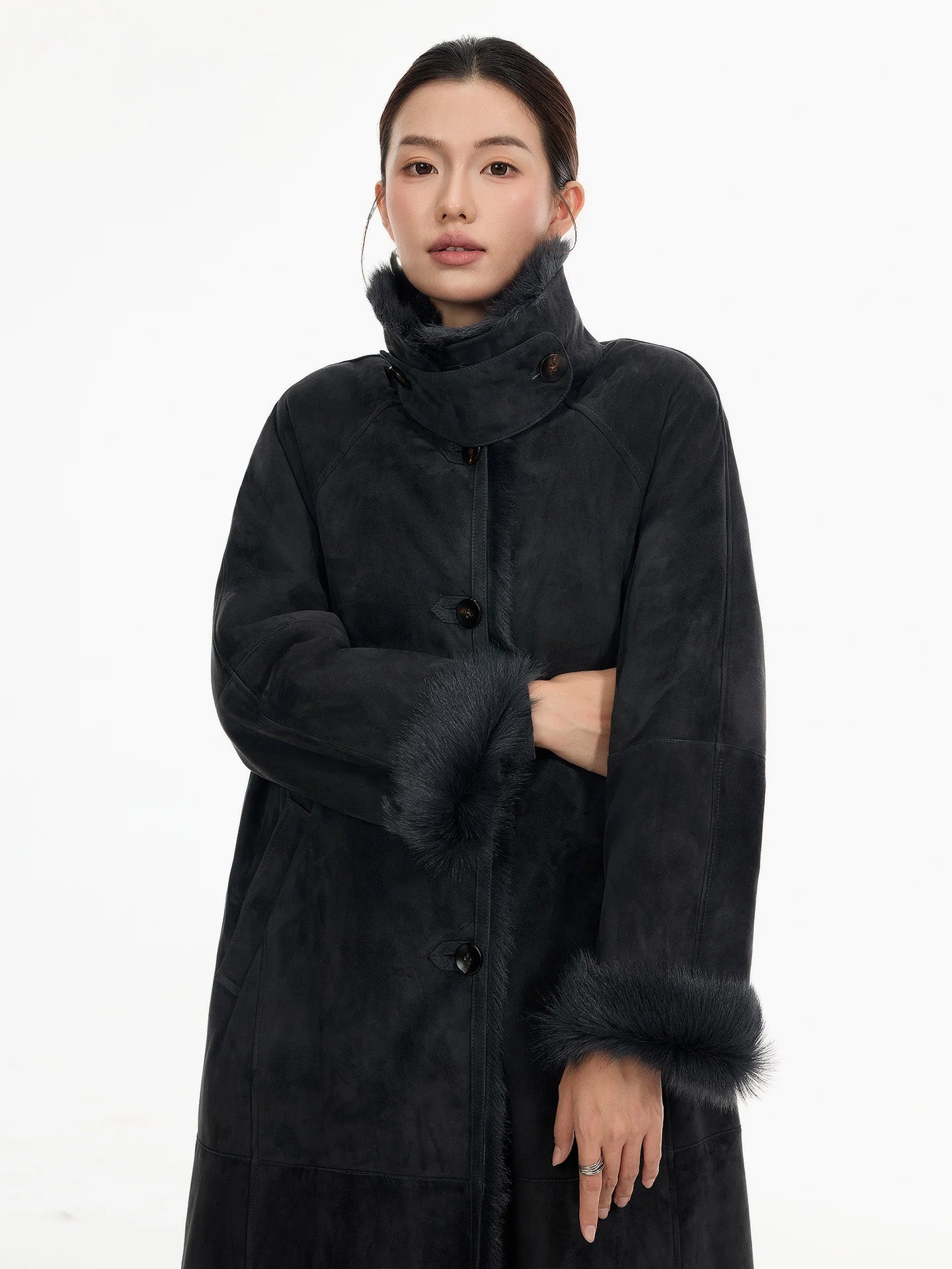 Model wearing a convertible collar goatskin coat in Tusch, one arm bent to reveal the soft structure of the sleeve and turned-back cuff — From Borcelleclothes.