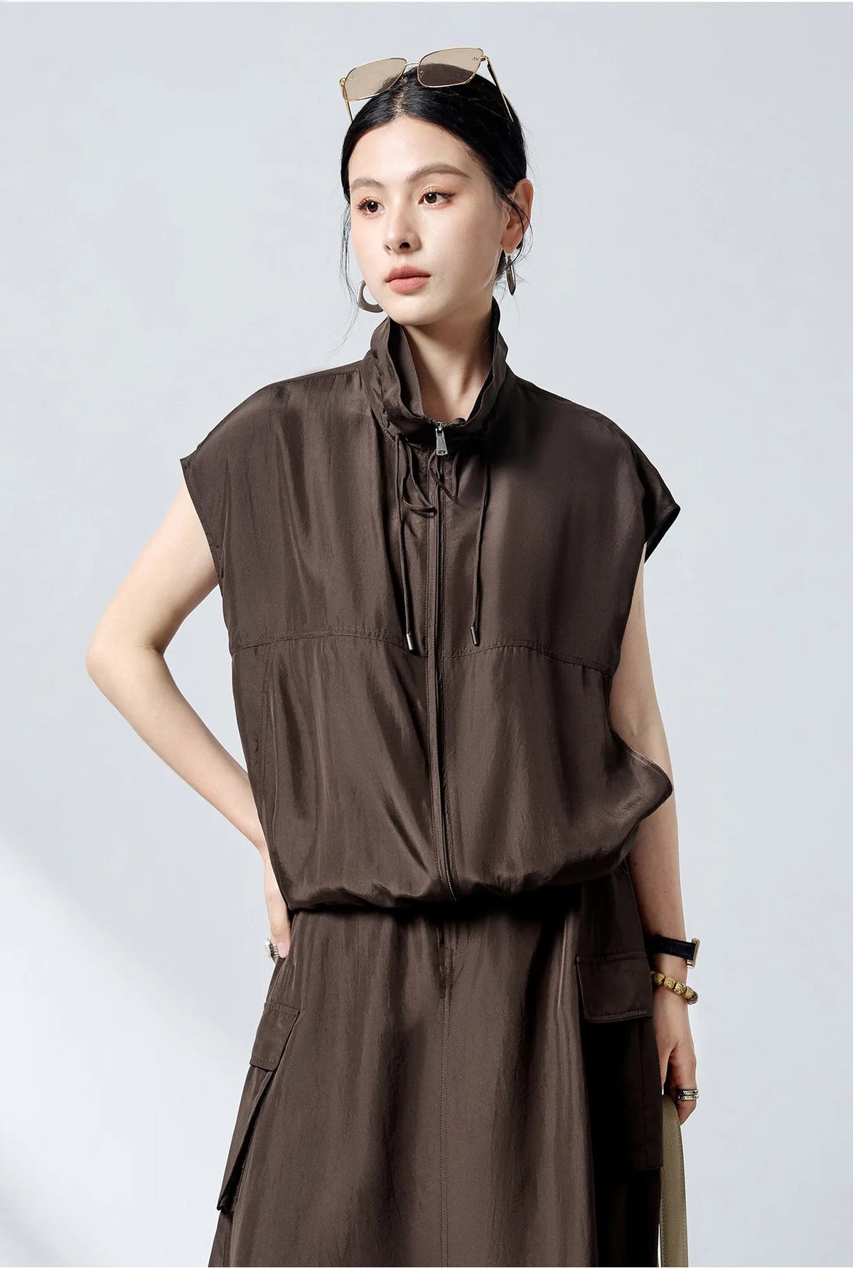 Model wearing zipped Mulberry silk convertible blouson with hand on hip — From Borcelleclothes.