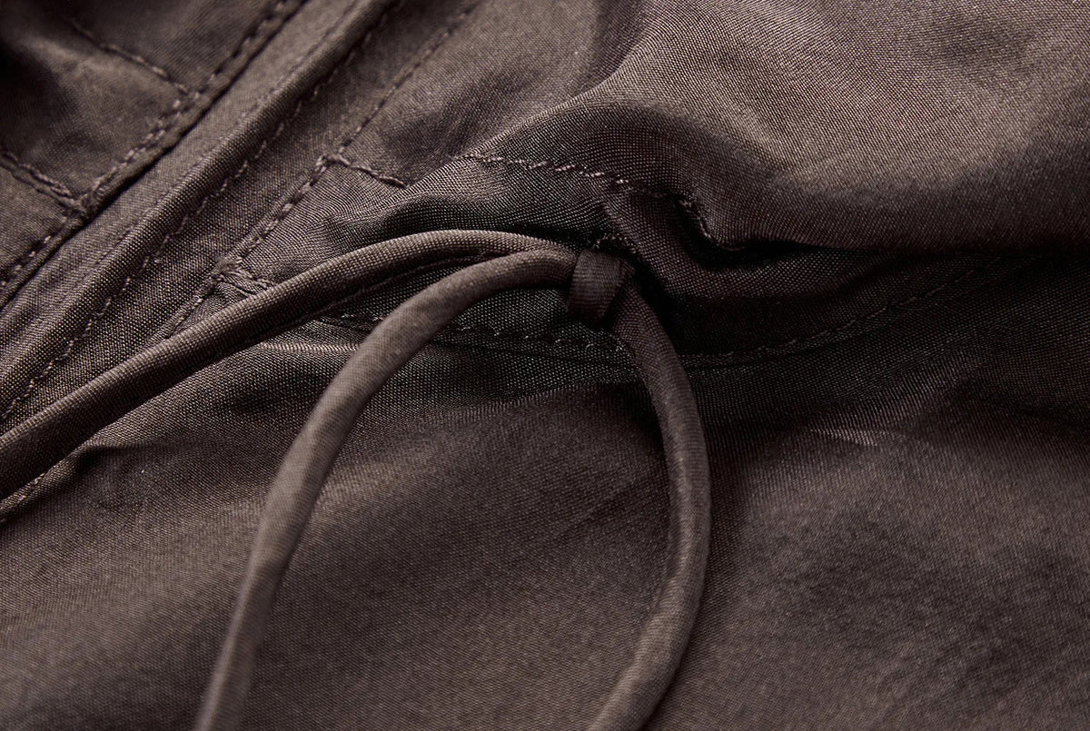 Close-up of silk tie end-knot with metallic tip on convertible collar — From Borcelleclothes.
