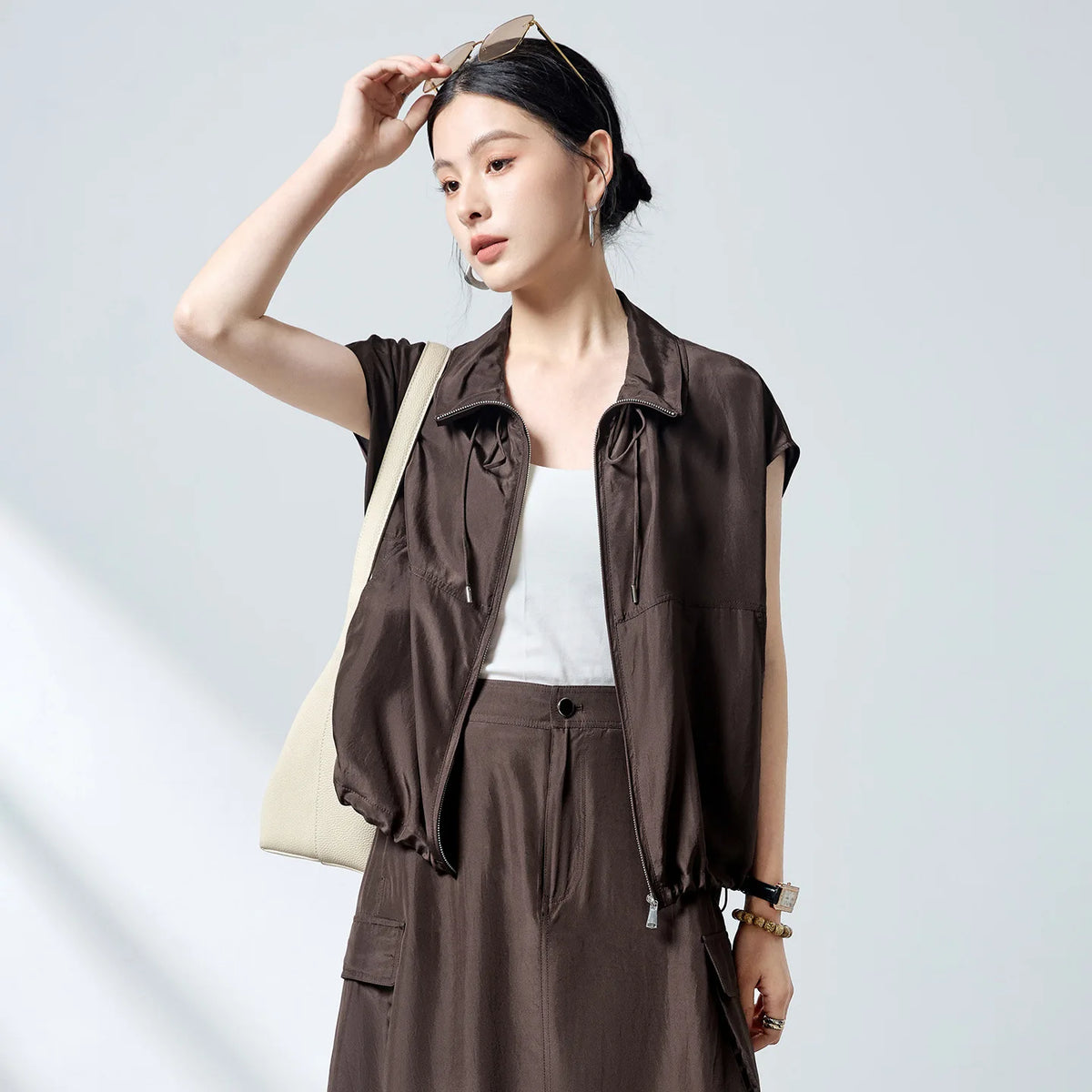Women's Lightweight 100% Mulberry Silk Habotai blouson in Bitter Chocolate, featuring a convertible stand collar, side slash pockets, and an adjustable drawstring hem. — From Borcelleclothes.