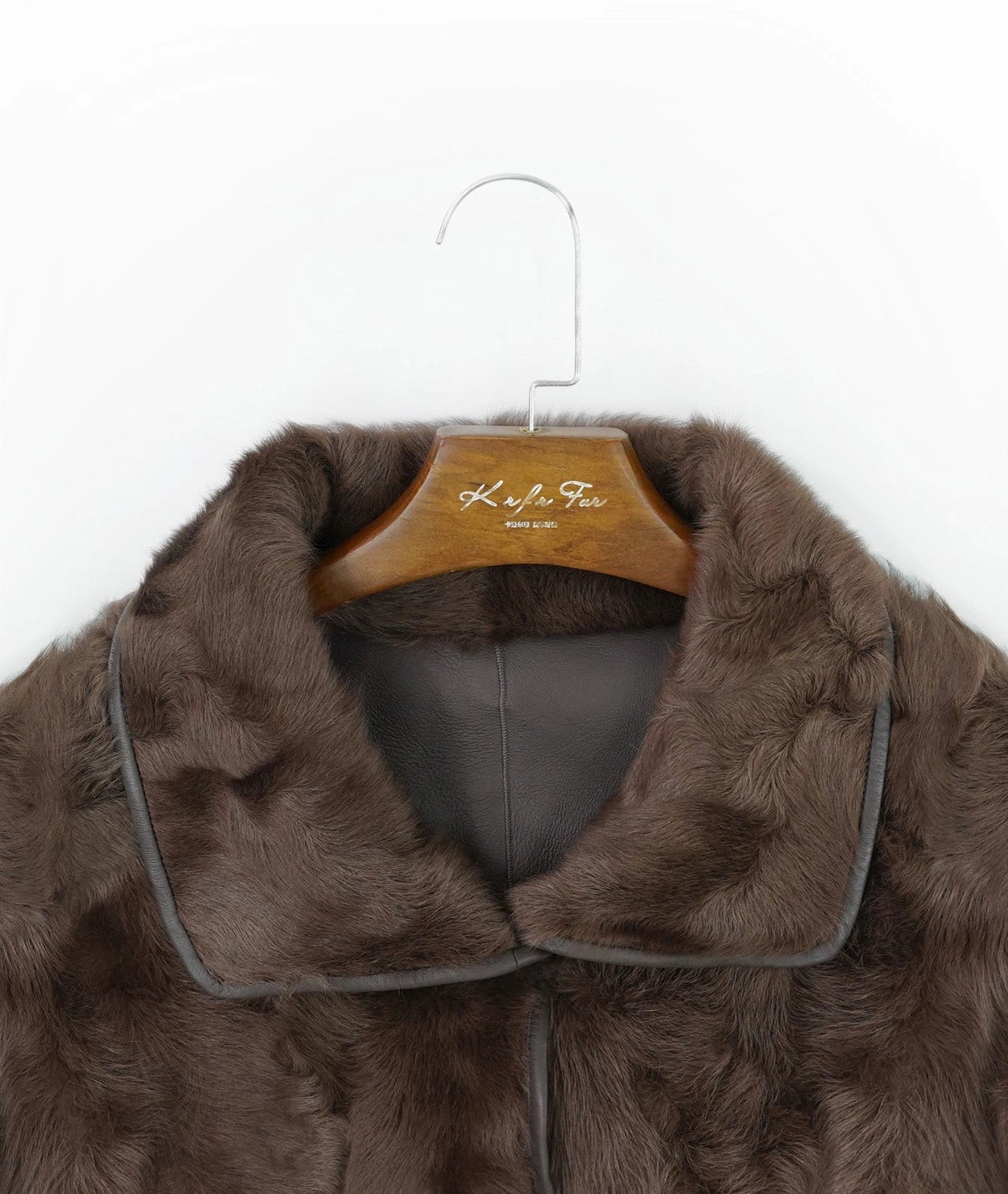 Detail of the double-layered collar in fur position, unfastened, showing natural texture and curved neckline — From Borcelleclothes.