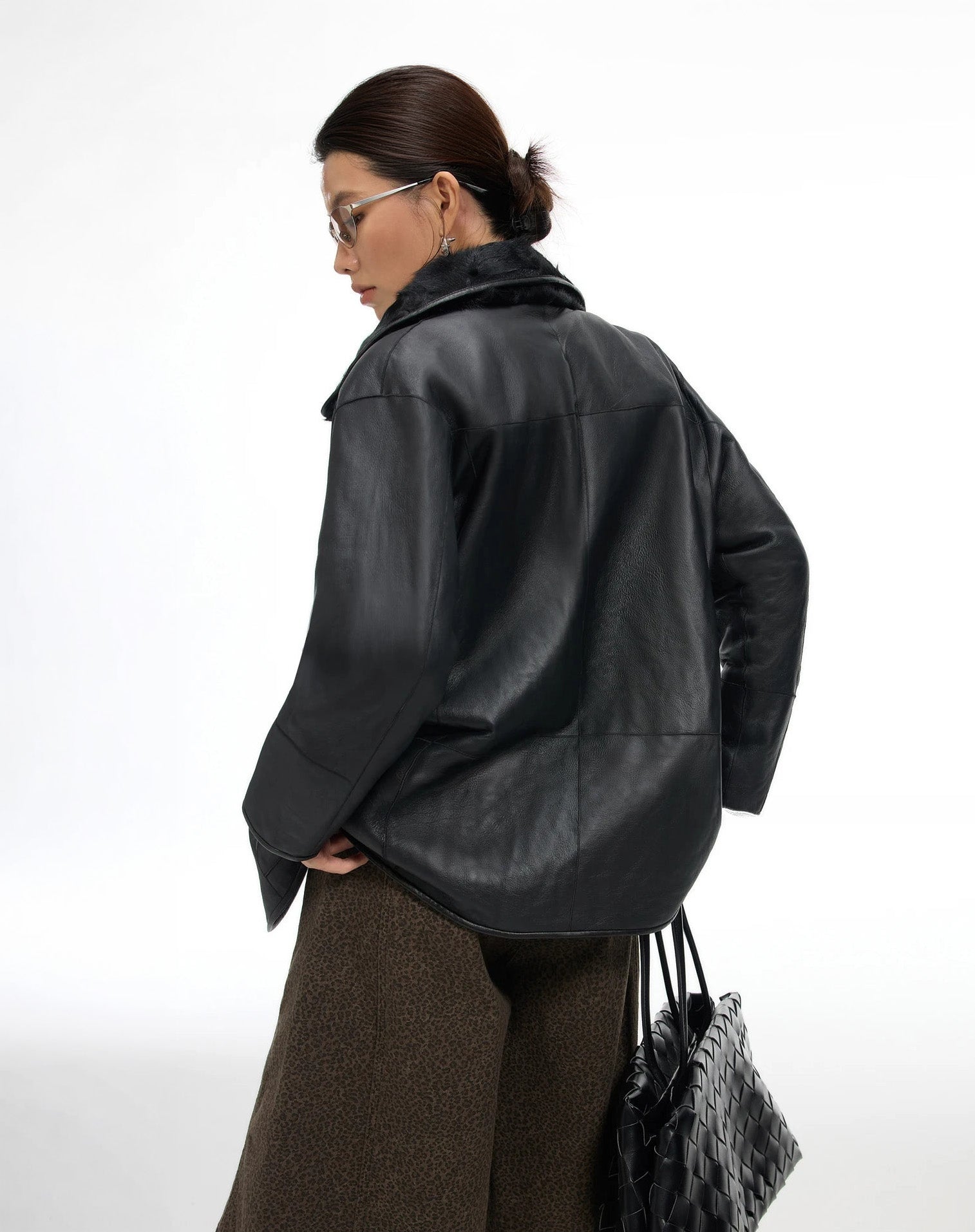 Back view of the Tusch Swell coat worn leather side out, showing the soft matte finish and clean structural line — From Borcelleclothes.