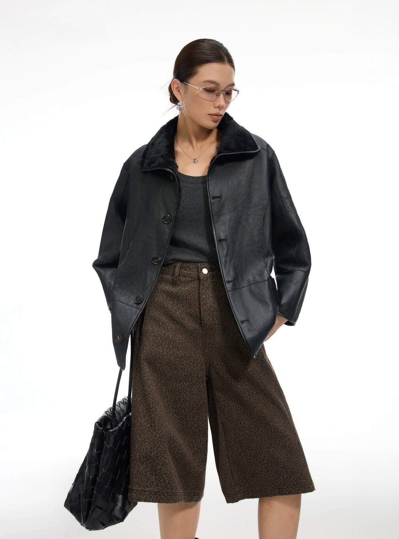 Model in a grounded stance wearing the coat leather side out, hands resting on hips, highlighting the relaxed shape — From Borcelleclothes.