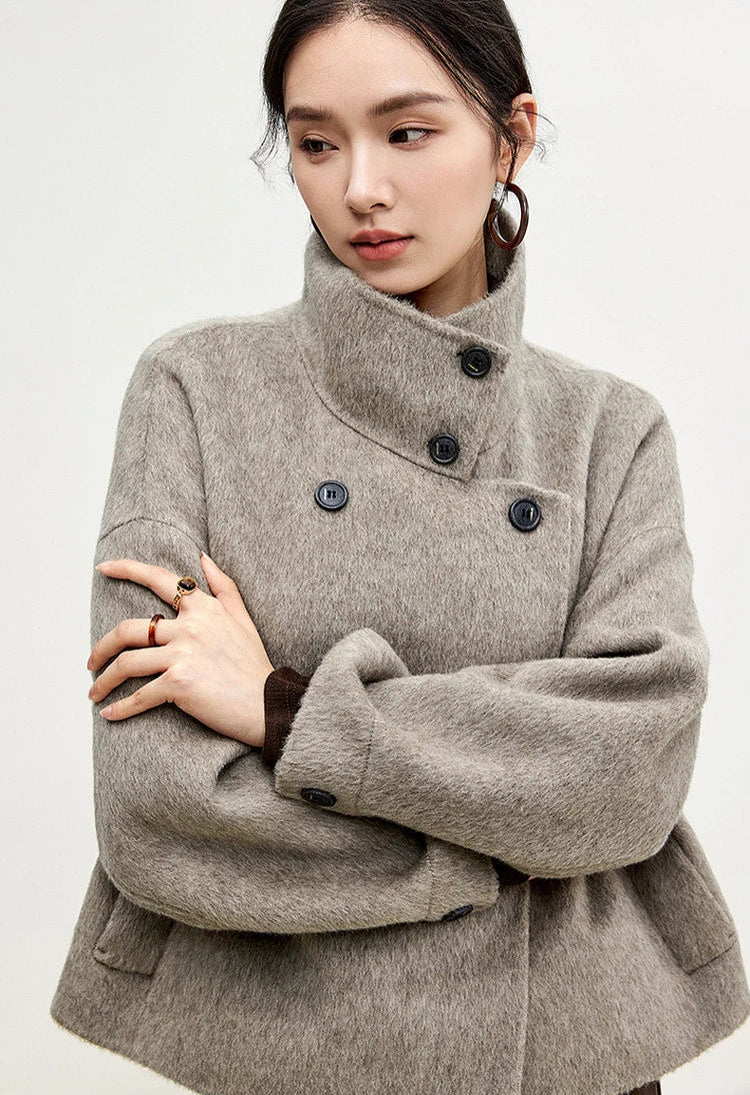 A poised stance showing the structured shoulders and the heavy drape of the double-sided wool. — From Borcelleclothes.