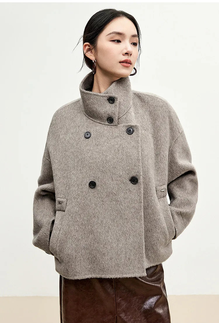 Effortless confidence: a woman standing relaxed with hands in the wide, functional pockets of her Gravity jacket. — From Borcelleclothes.