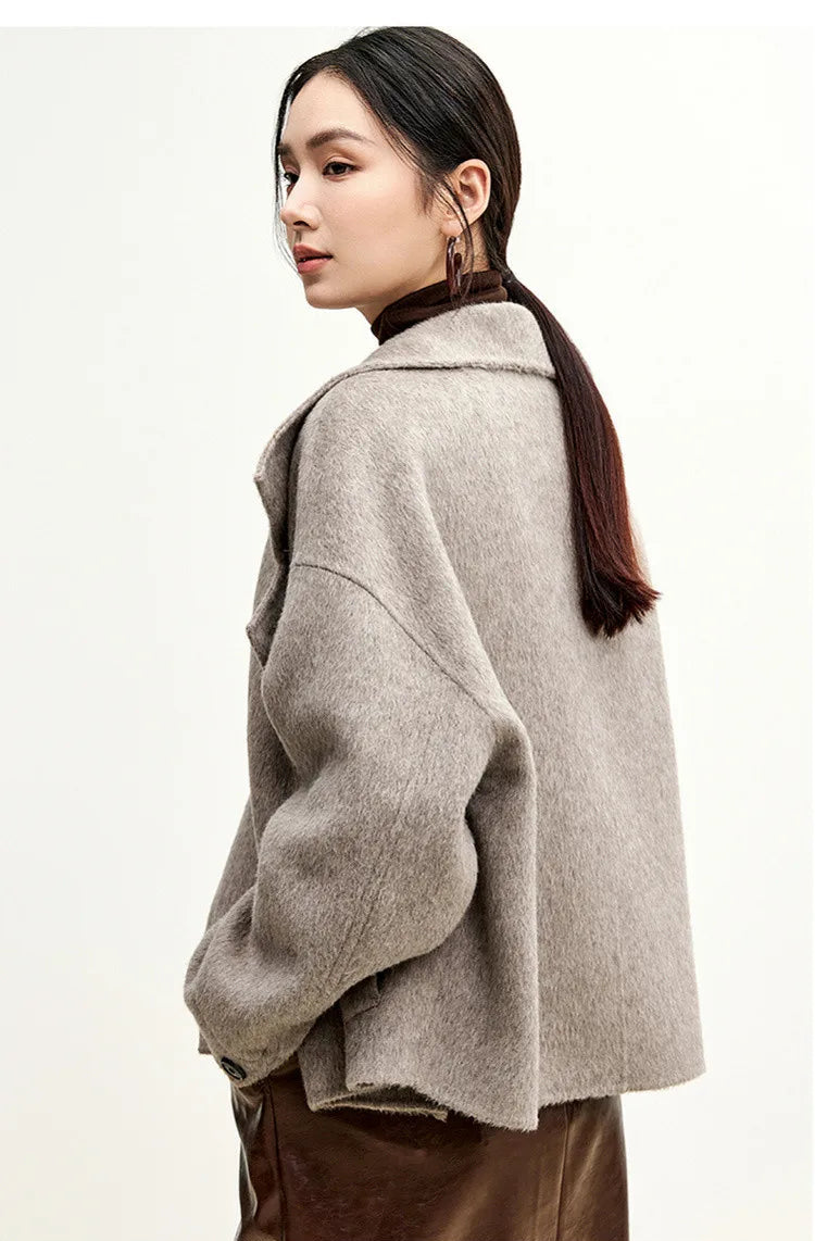 Side view of a woman wearing a wool jacket in Gravity color.  — From Borcelleclothes.