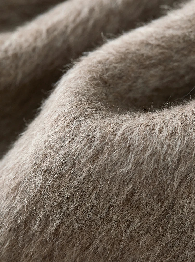 Close-up of the 980g wool, showing the sculptural "gravity wave" in the fabric’s natural fold and plush texture. — From Borcelleclothes.