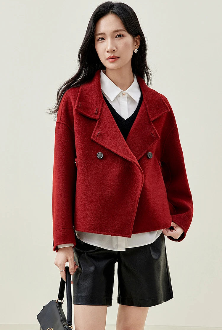 A woman feeling the weight of the 100% virgin wool, connecting with the material's density. — From Borcelleclothes.