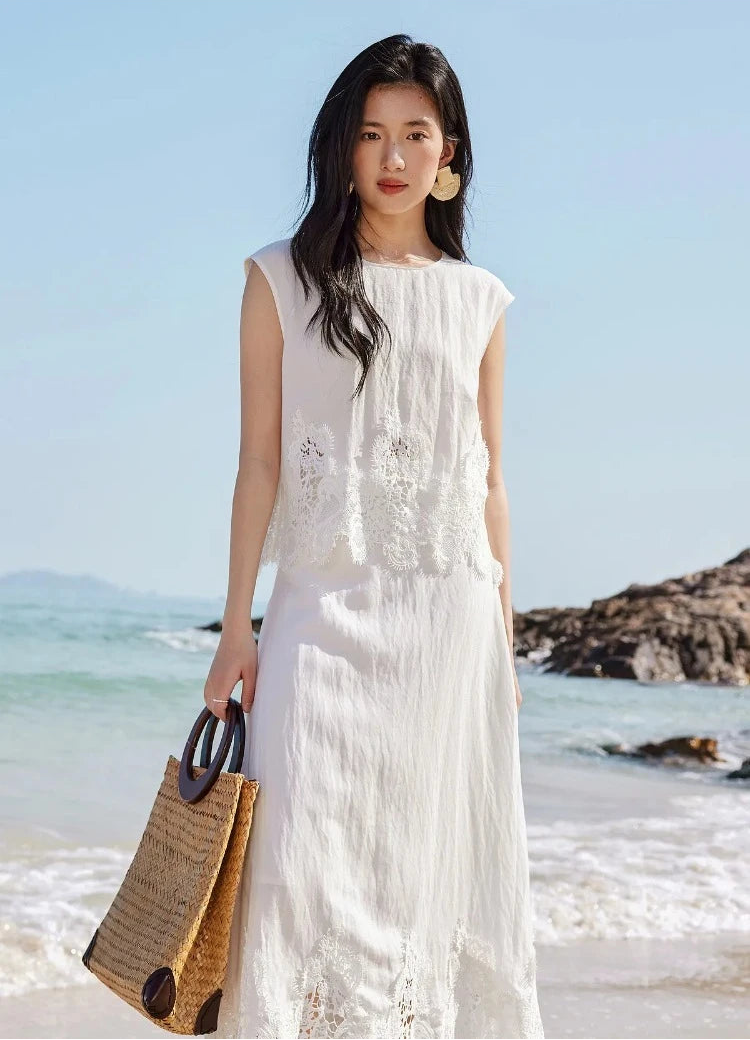 A woman holding a stylish bag, wearing the Foam Kiss corded lace two-piece set. — From Borcelleclothes.
