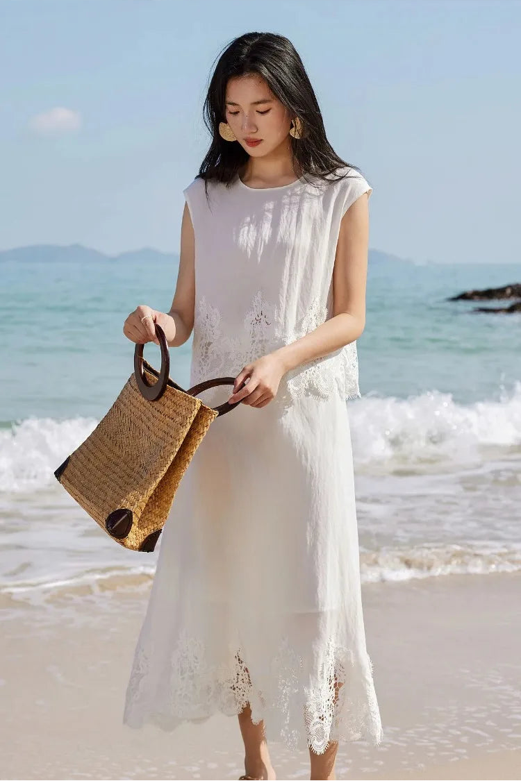 A woman opening her bag, styled with the Foam Kiss corded lace two-piece set. — From Borcelleclothes.