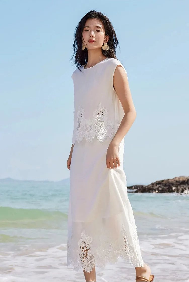 A woman gently touching the linen skirt of the Foam Kiss corded lace two-piece set. — From Borcelleclothes.