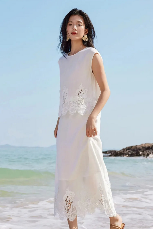 A woman gently touching the linen skirt of the Foam Kiss corded lace two-piece set. — From Borcelleclothes.