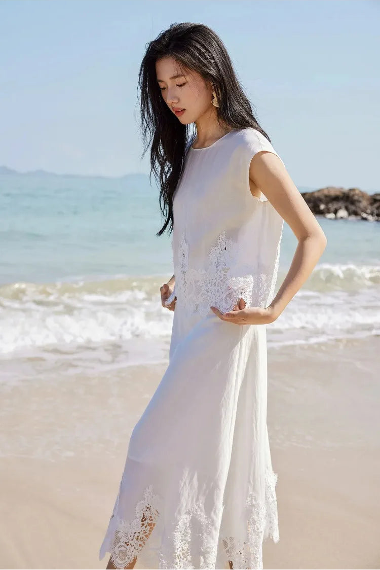 A woman touching the scalloped lace hem of the Foam Kiss cropped top. — From Borcelleclothes.