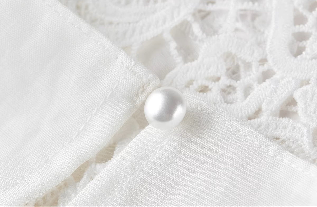Close-up of the elegant pearl button closure on the back of the Foam Kiss top. — From Borcelleclothes.