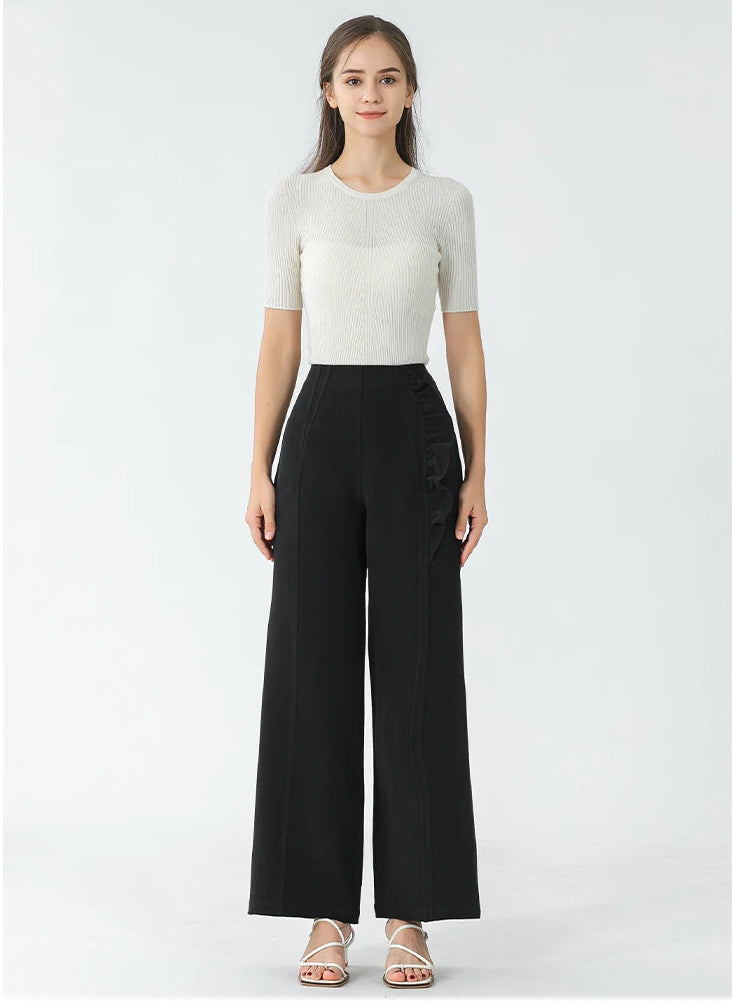 Full-length view of high-waisted silk wide-leg trousers in Couture Noir on a standing model — From Borcelleclothes.