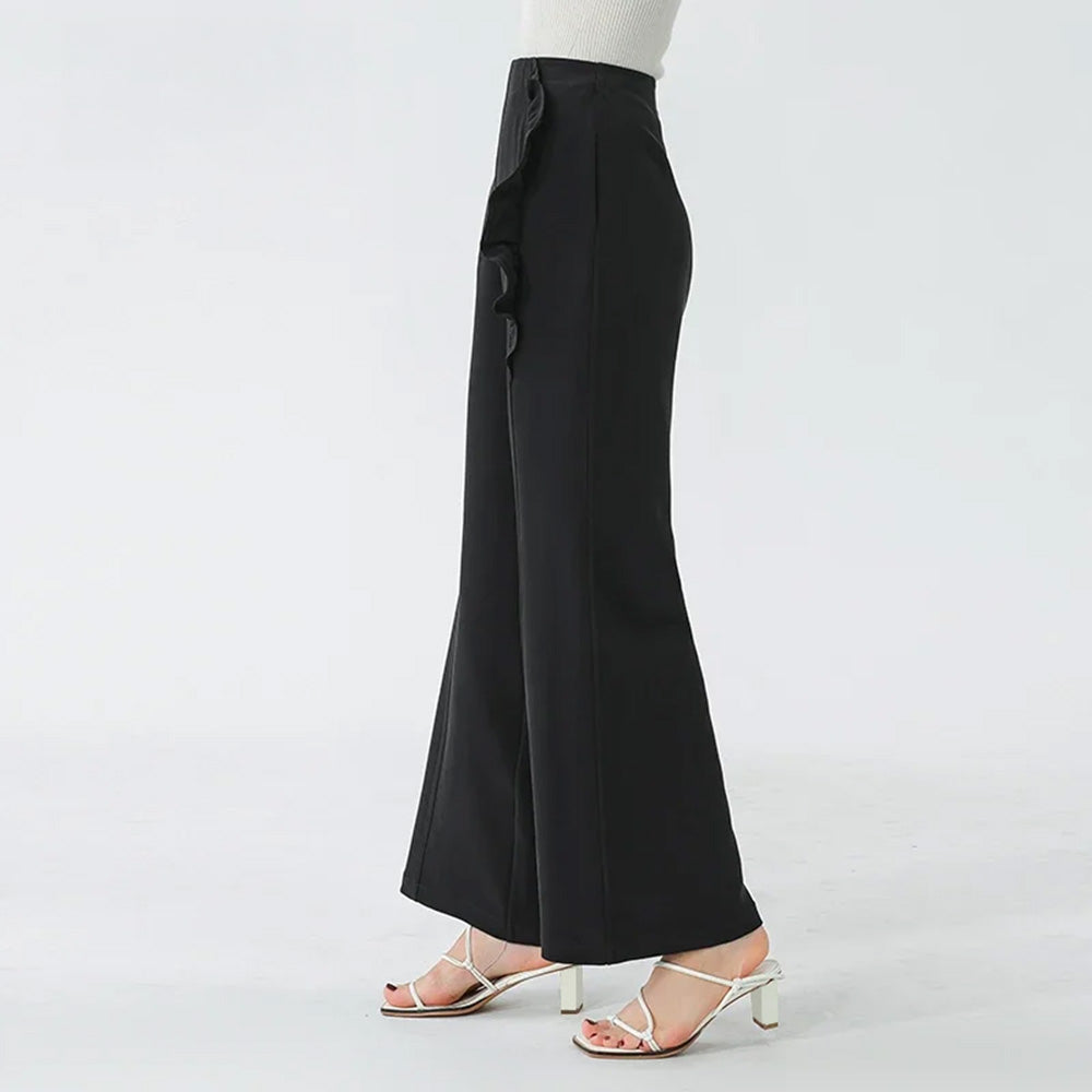 Women's Architectural wide-leg trousers tailored from 45 momme Mulberry silk crepe in Couture Noir. Features a continuous curved inset panel with an integrated ruffle. — From Borcelleclothes.