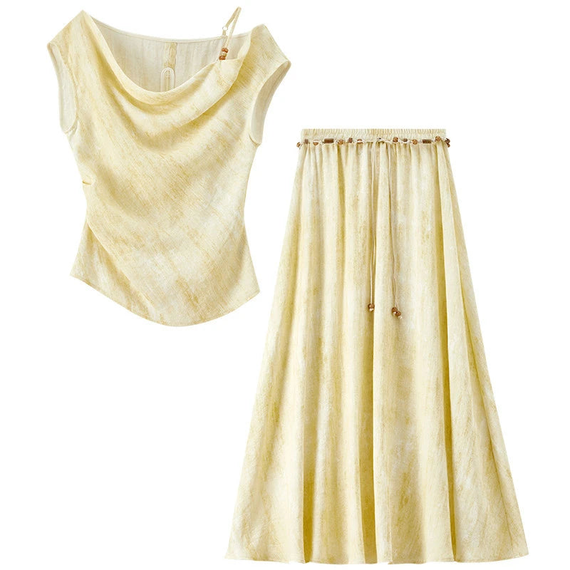 Studio flat lay of the Urban Hippolita set, showing the asymmetrical front hem — From Borcelleclothes.