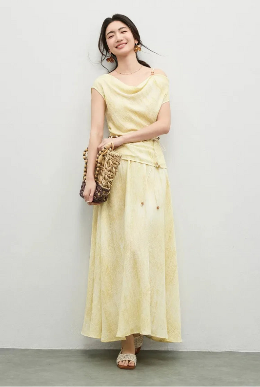 A woman gracefully holding a woven bag with both hands, showcasing the fluid Urban Hippolita viscose set — From Borcelleclothes.